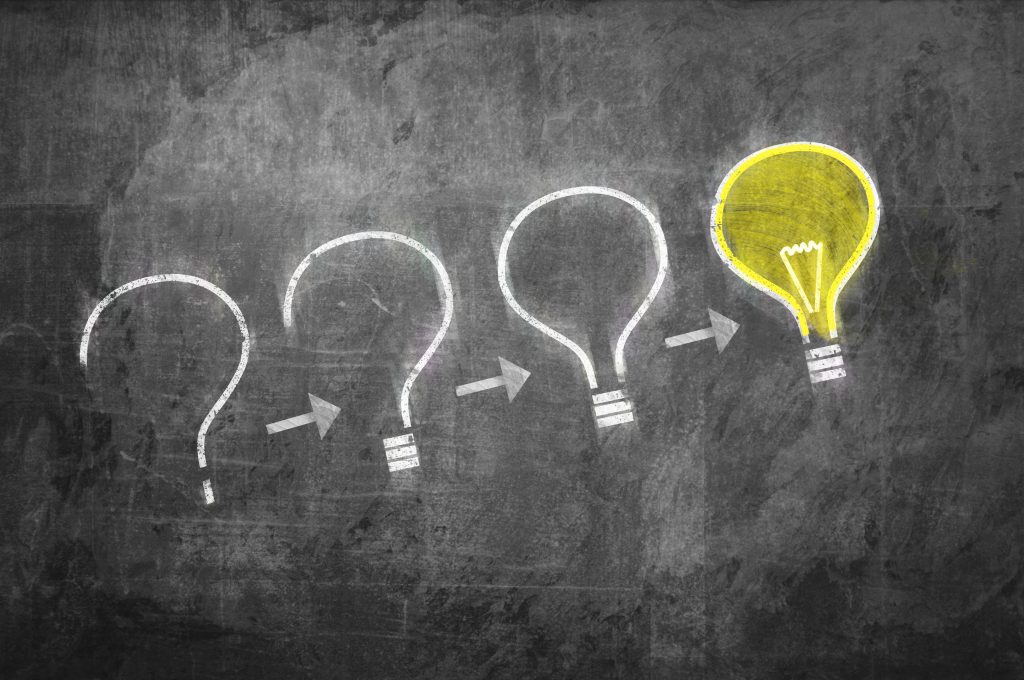 4 chalk drawn lightbulbs representing brand strategy development